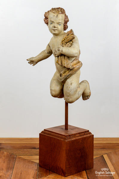 18th Century carved & painted putto on stand