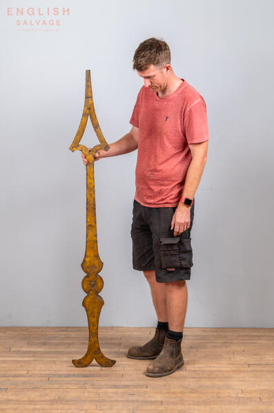 A large antique clock dial hand