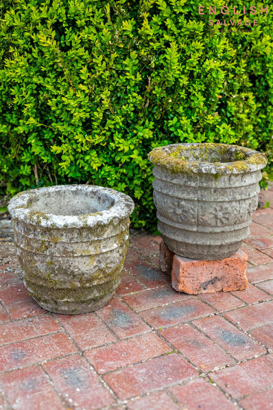 A pair of weathered ornate planters