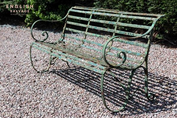 An antique wrought iron strapwork bench