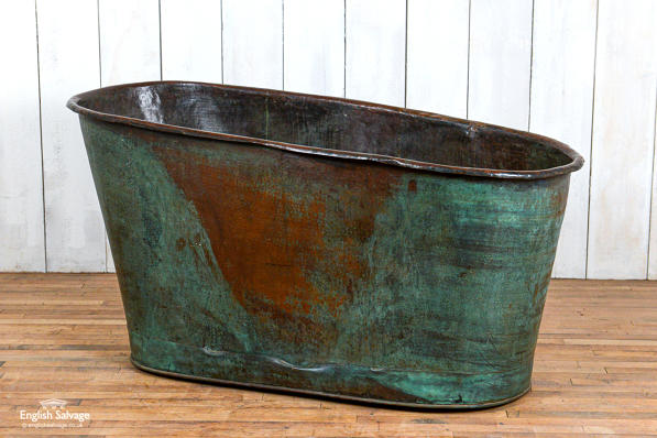 Antique copper bath tub with verdigris patina