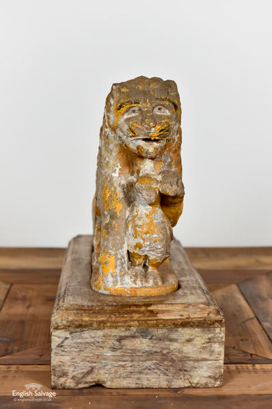 Antique stone lion with bird