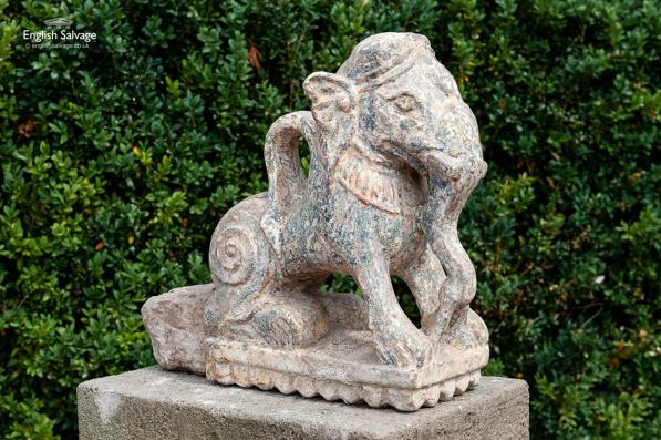 Antique stone statue of a seated elephant