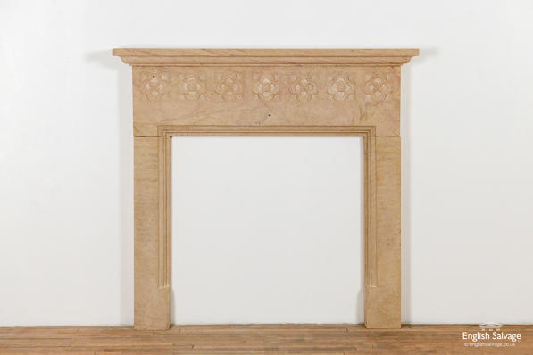 Beige gothic style sandstone fire surround