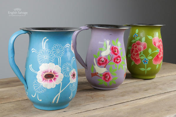Brightly painted floral enamelled jugs