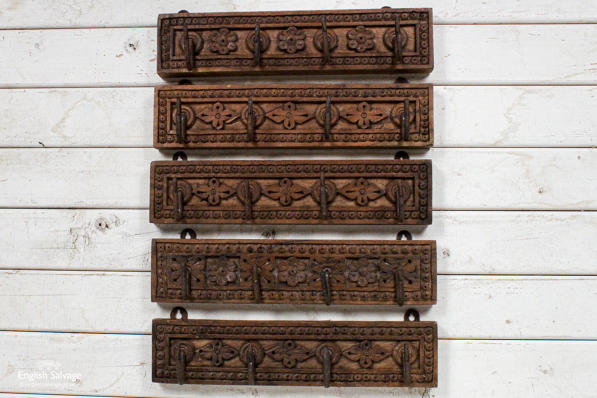 Carved, floral boards with four iron hooks