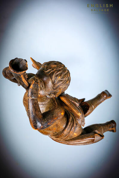 Carved wood flying cherub with horn