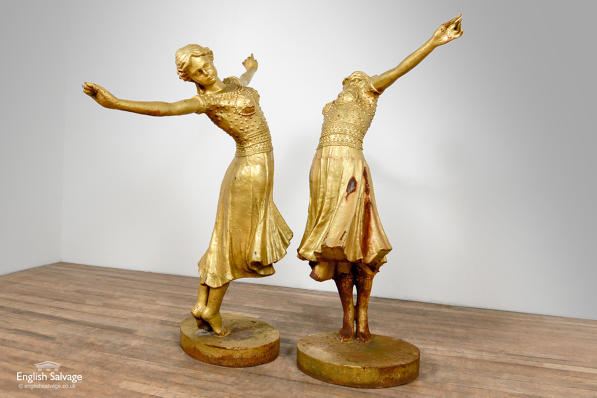 Cast iron gold coloured statues of dancers 