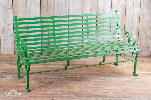 Green scrolled three seater strapwork bench