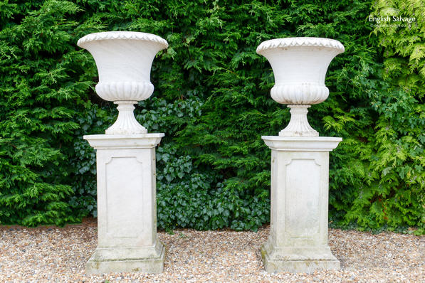 Hand carved sandstone campana urns on plinths