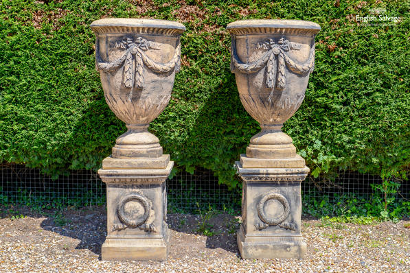 Impressive composite stone urns on plinths