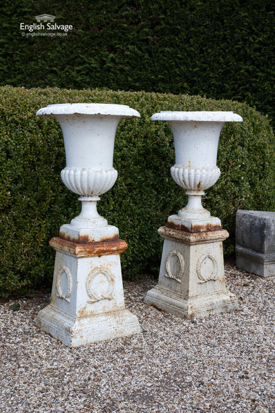 Original cast iron Campana urns on plinths