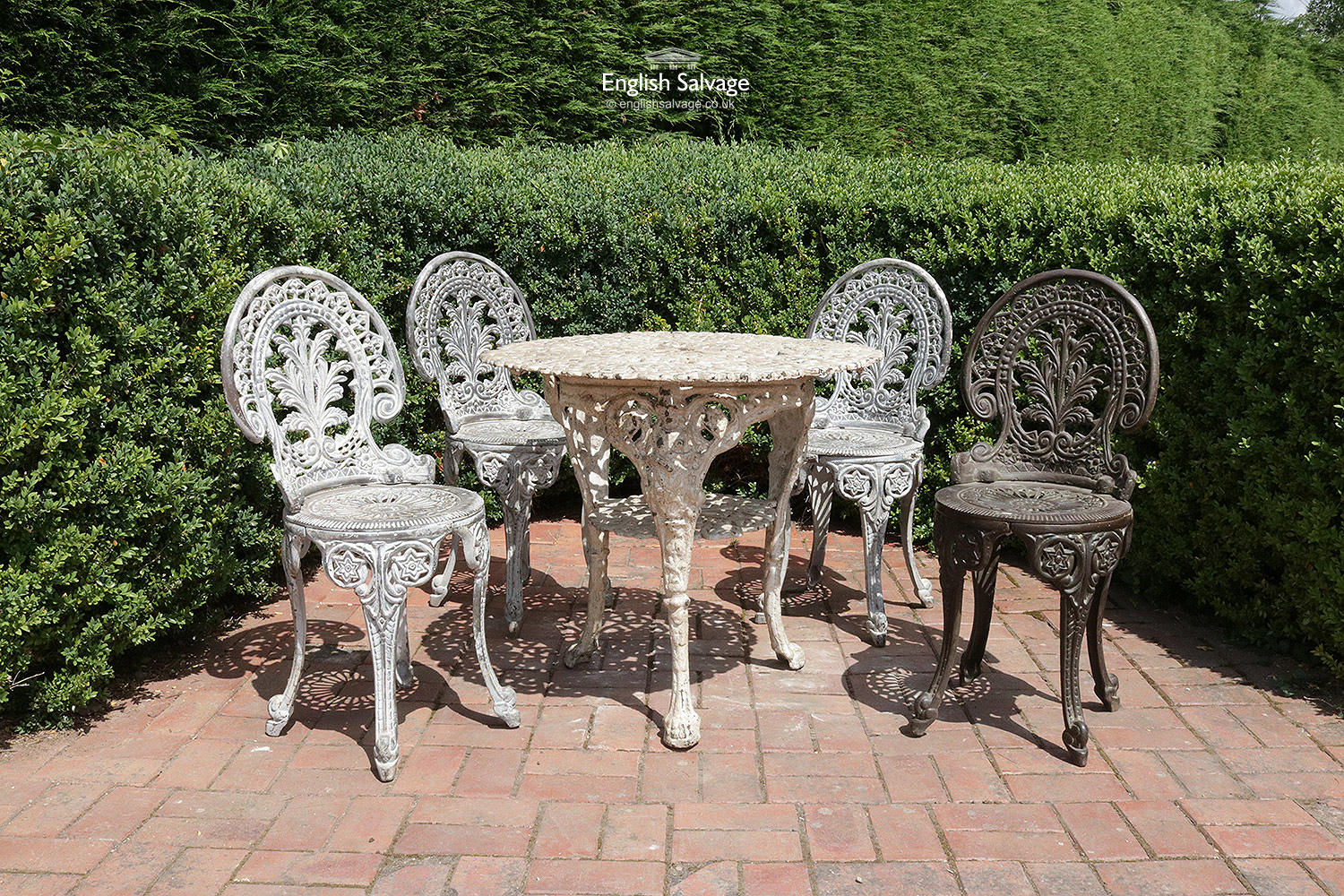 Ornate cast iron garden table and four chairs