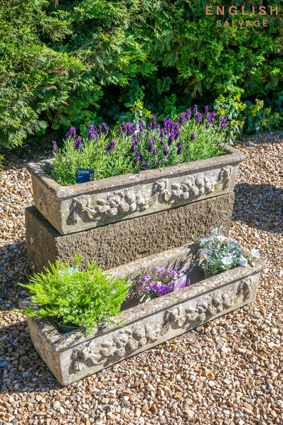 Ornate weathered composition stone troughs