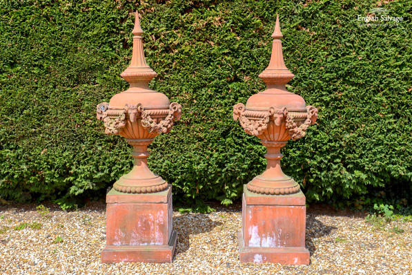 Pair composition stone finials on stands