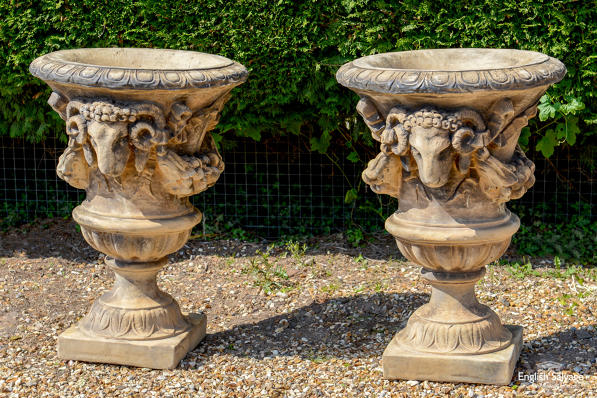 Pair of large composition rams head urns