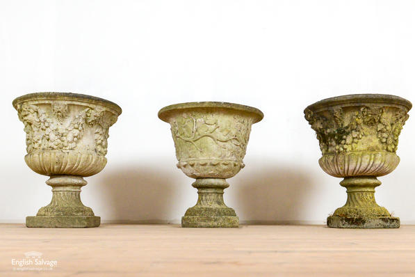 Pair of weathered composition stone urns