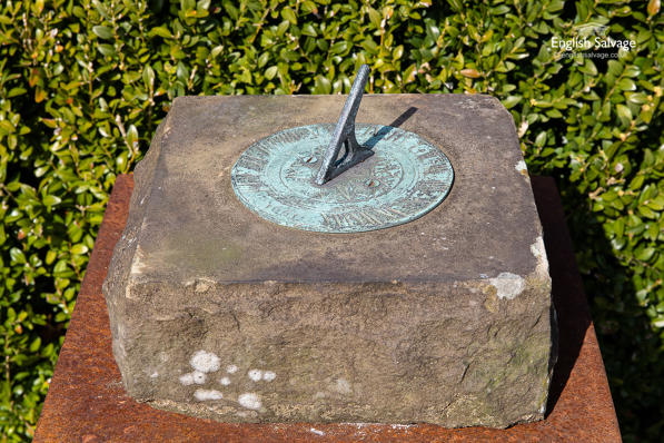 Patinated bronze sundial on sandstone base