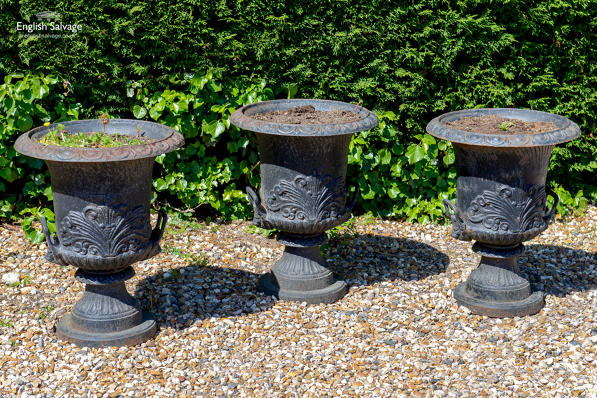Set of three salvaged cast iron urns