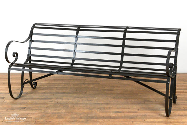 Slatted wrought iron scroll arm garden bench