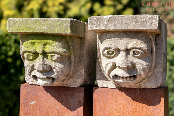Two large old carved stone gargoyles