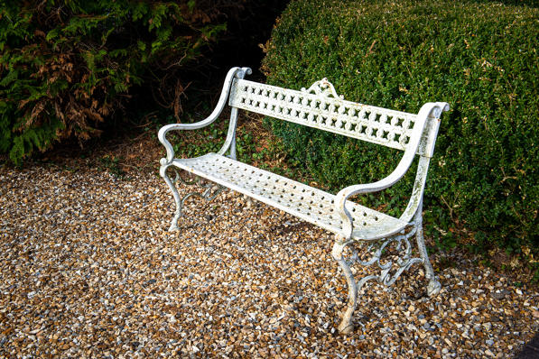 Weathered ornate iron garden bench