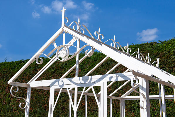 Wrought iron white greenhouse with glass